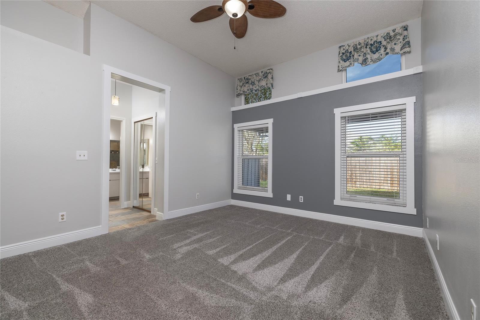 Primary bedroom with high ceilings