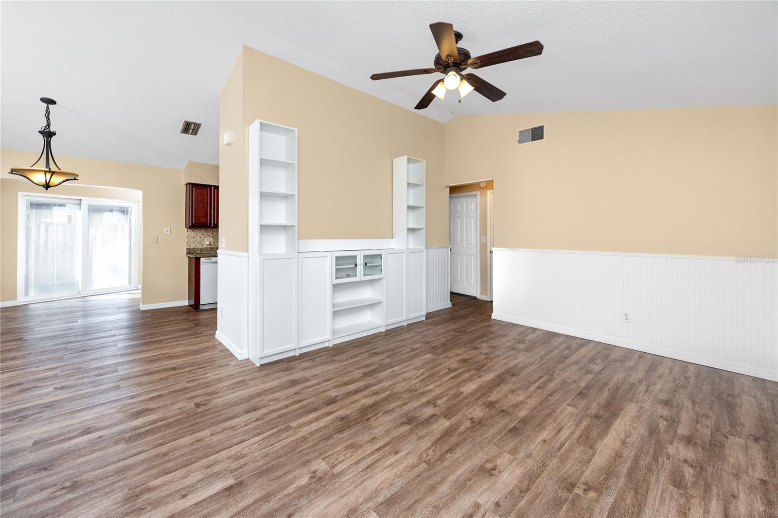 Open floor plan with built in storage and luxury vinyl plank flooring.