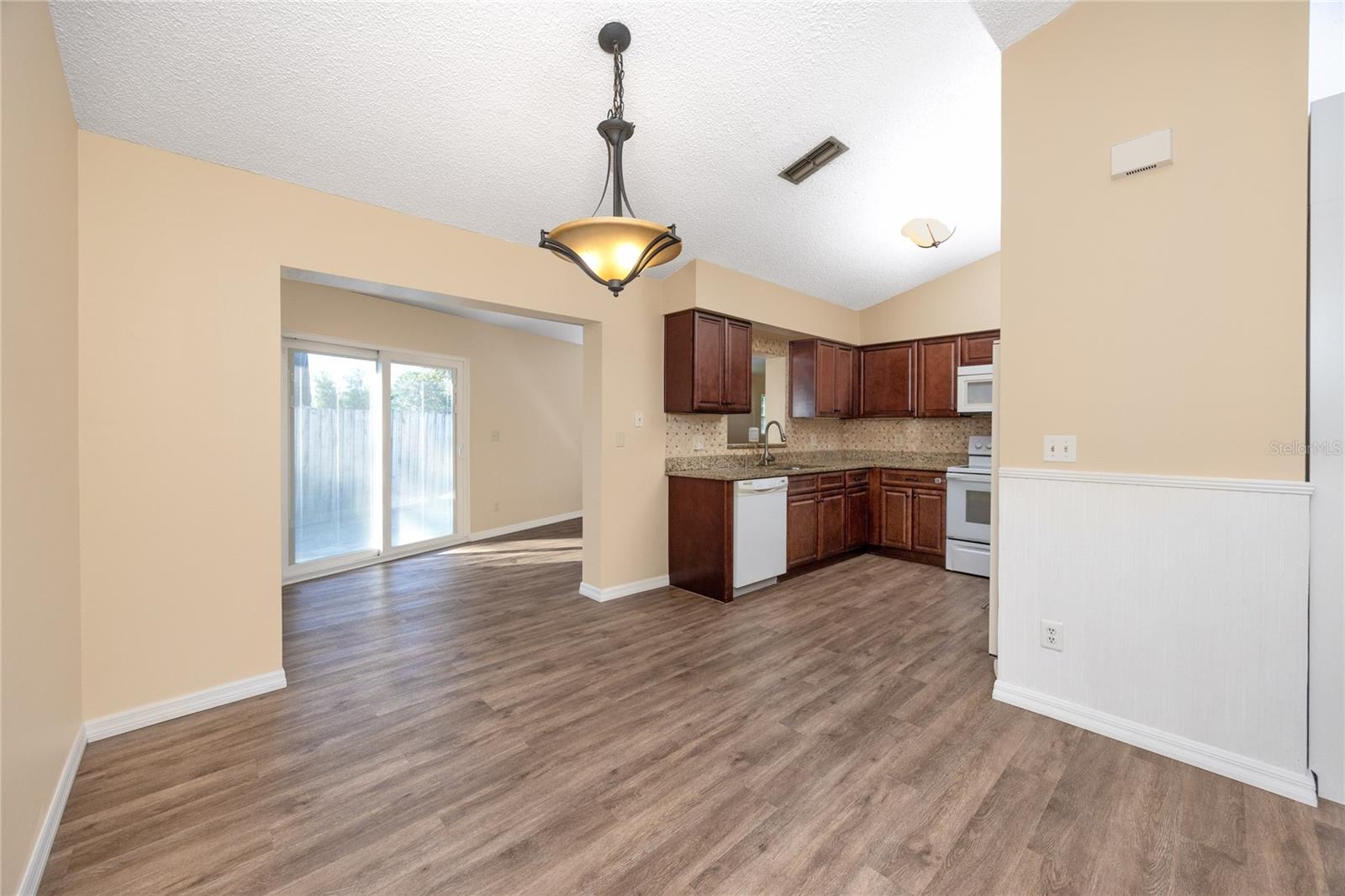 Eating space across from the kitchen and the view into the enclosed bonus room.