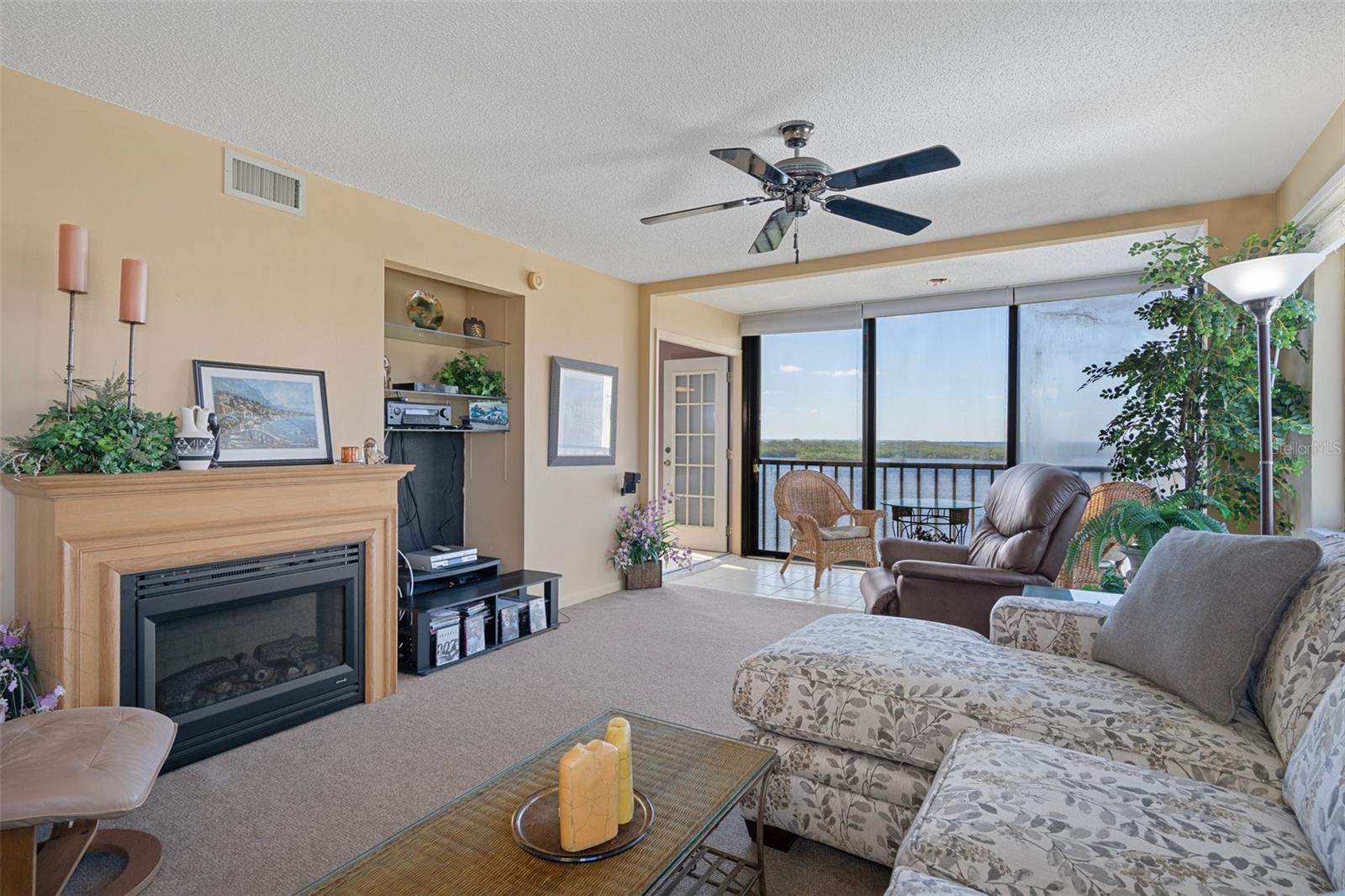 Great room with electric fireplace and waterfront view
