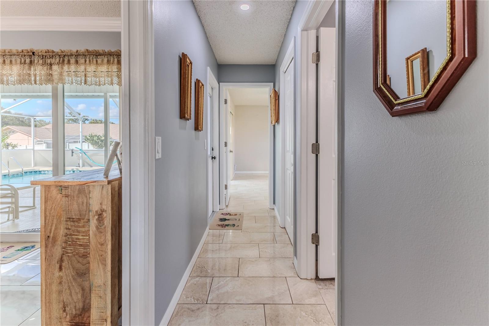 Hallway to split 2nd and 3rd bedrooms.  Door to Pool Area making this the pool bath.