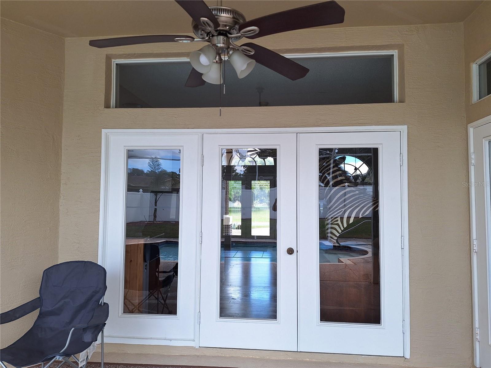 Triple Wide French Doors to the 34ft Covered Poolside Lanai