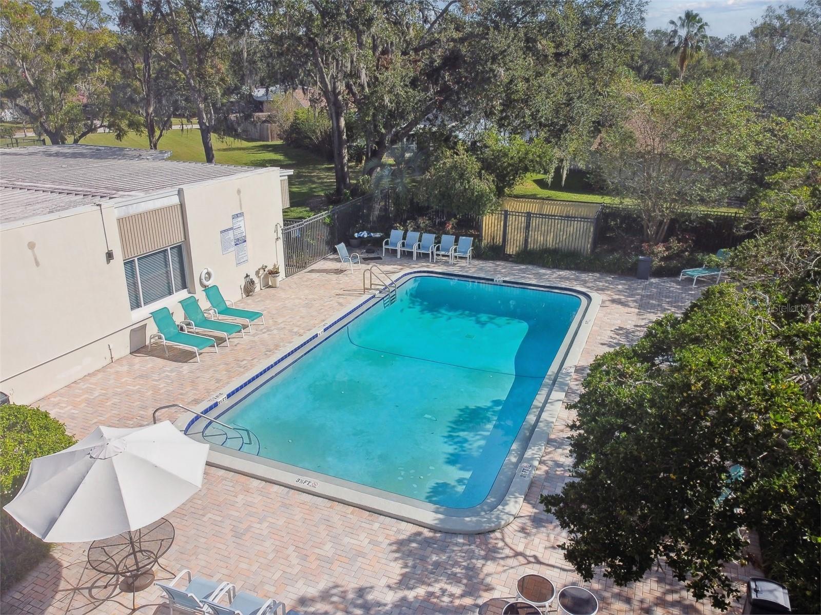 Community pool with lots of lounging area