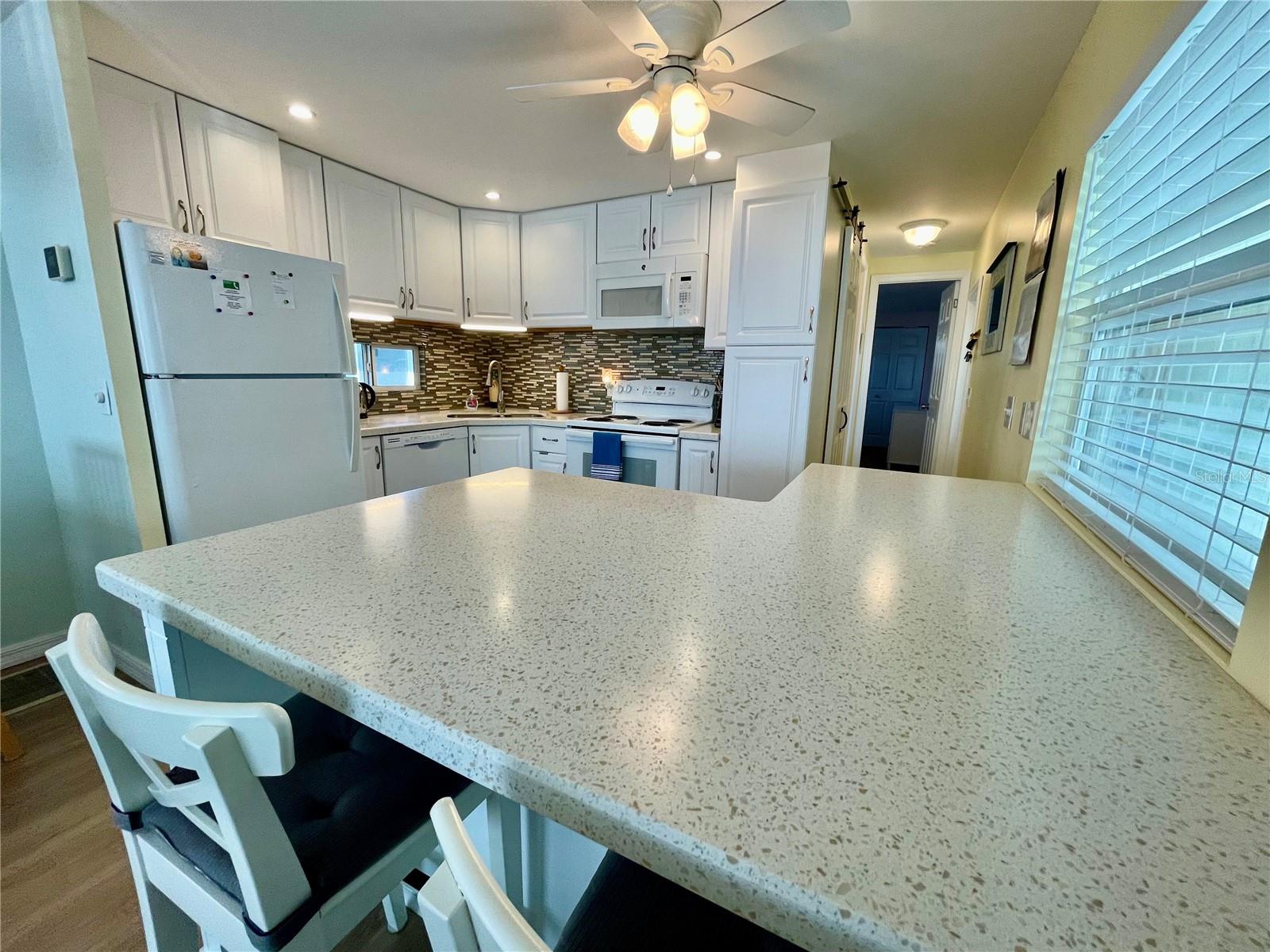 Beautifully updated kitchen. Solid surface countertops