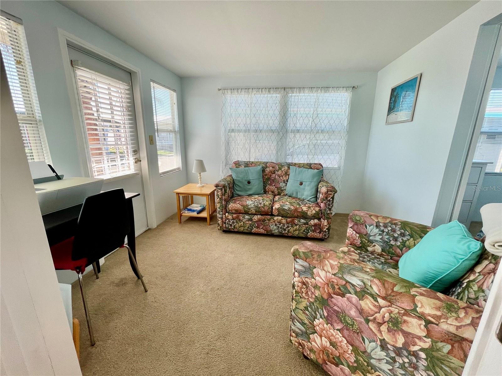 The front door @ the front porch opens up to this room (bonus room). 2nd bedroom thru the opening on the right.