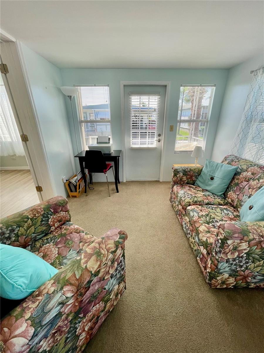 Looking from 2nd bedroom, into the bonus room and front door area.