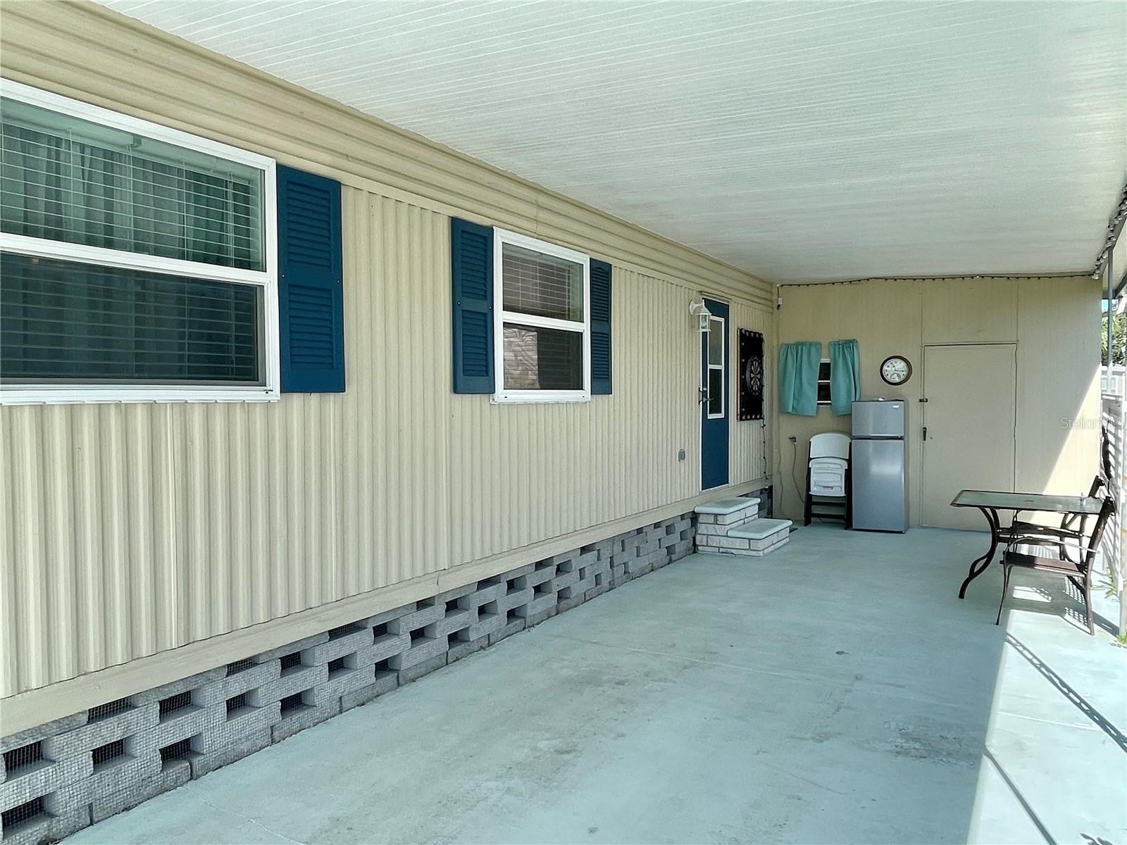 Carport. Refrigerator shown here and chairs do NOT convey with the home.