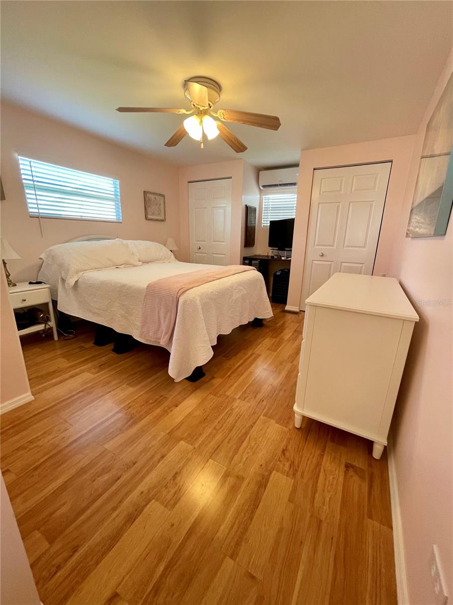 Primary bedroom, bathroom to the right across from the bed. This room has 3 closets, 2 shown here.