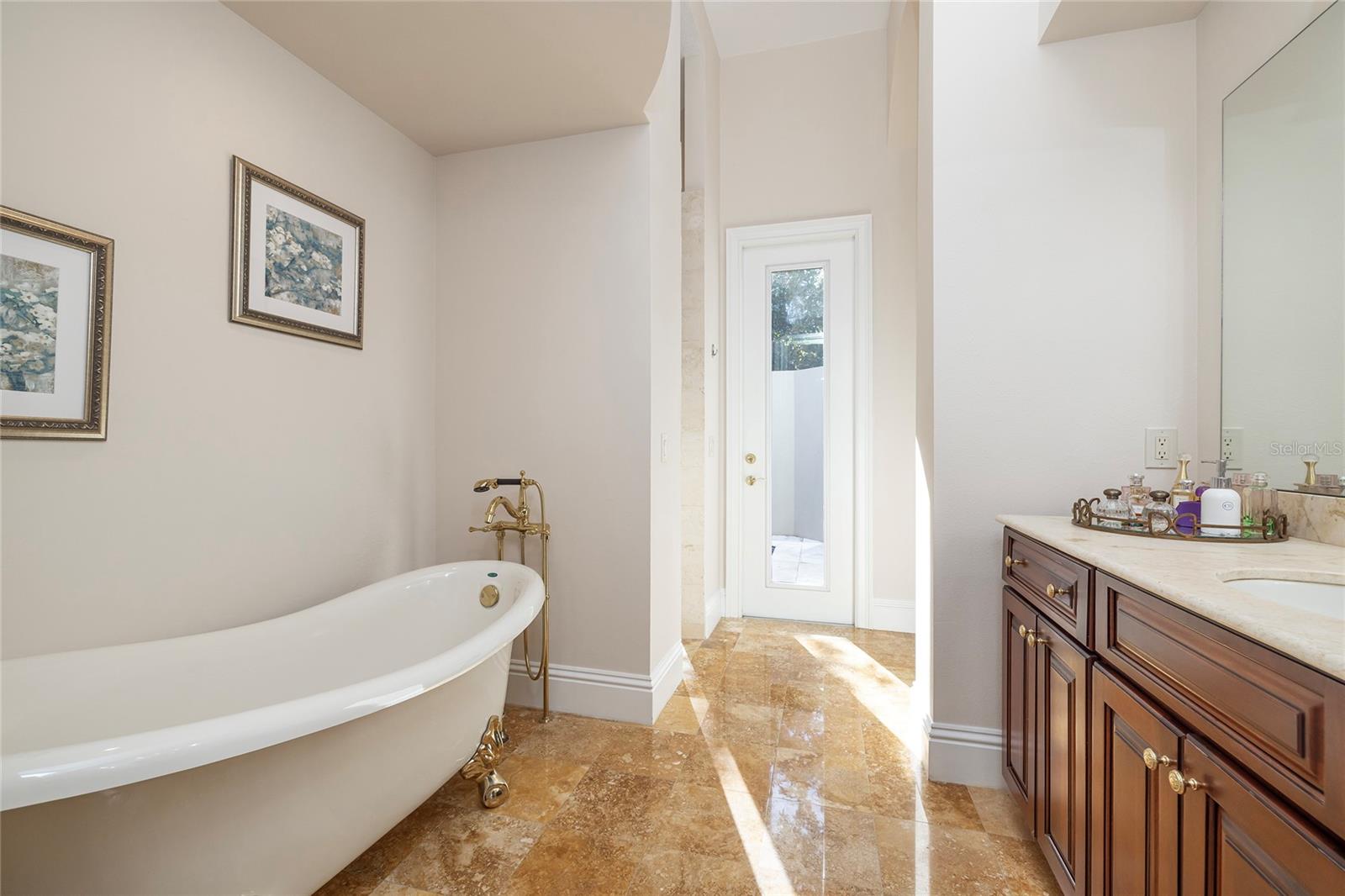 Private primary suite bath with claw foot tub and private water closet with bidet.