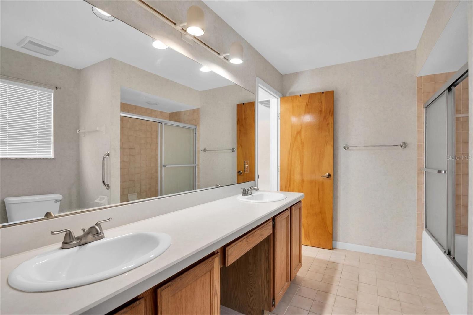 Upstairs Secondary bathroom with dual sinks