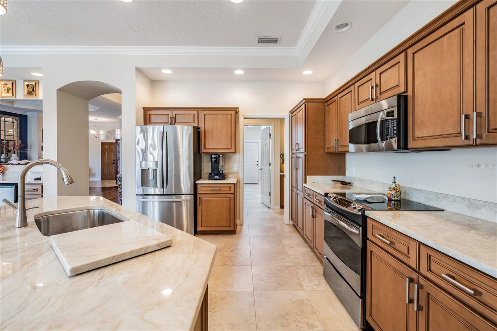 Updated Kitchen - New Cabinets, New Quartzite, Stainless Steel Appliances, Crown Molding and Drop Down Lights.