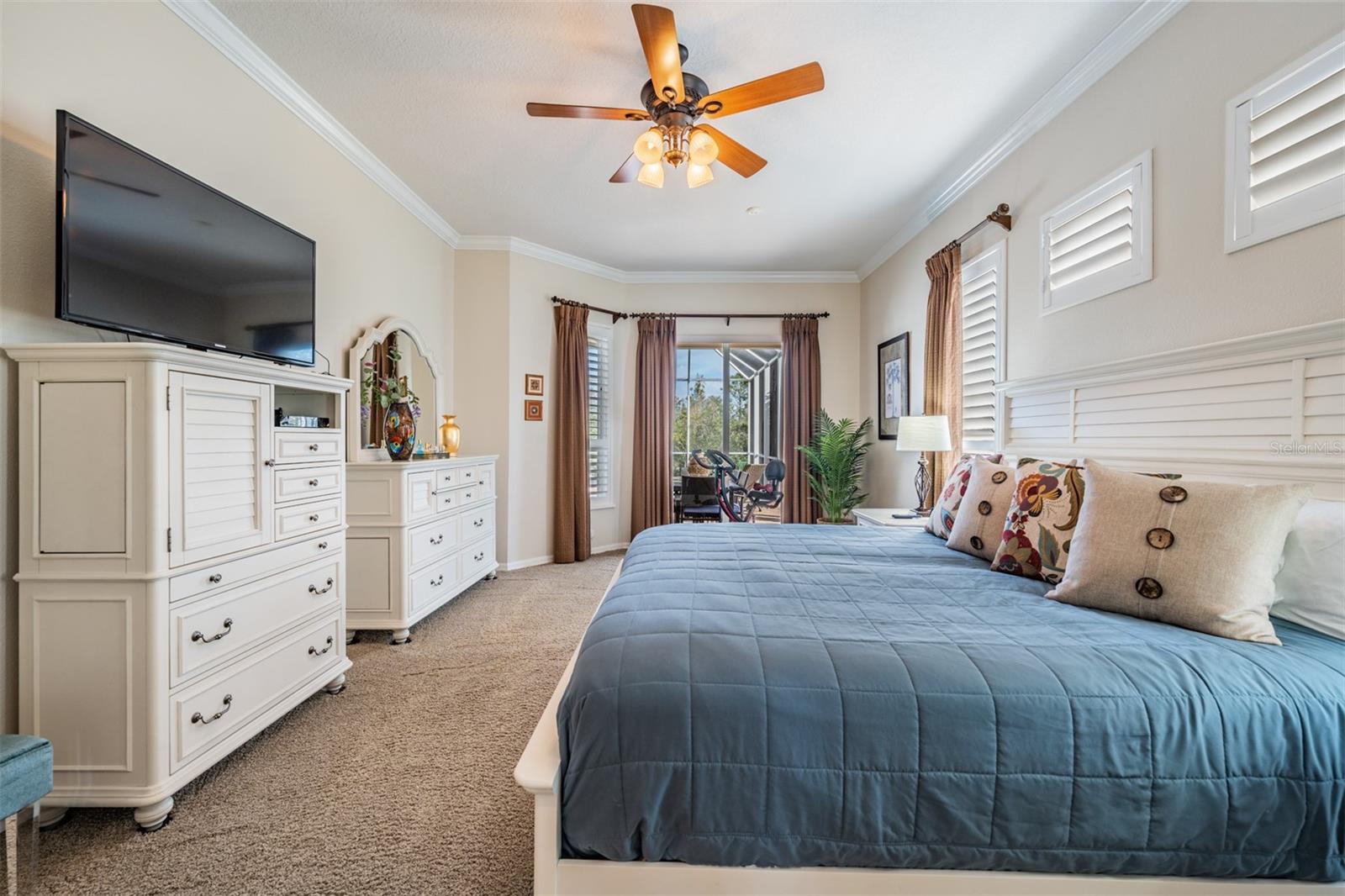 Super Large Primary Bedroom with Crown Molding, Plantation Shutters, Ceiling Fan with Light Fixture.