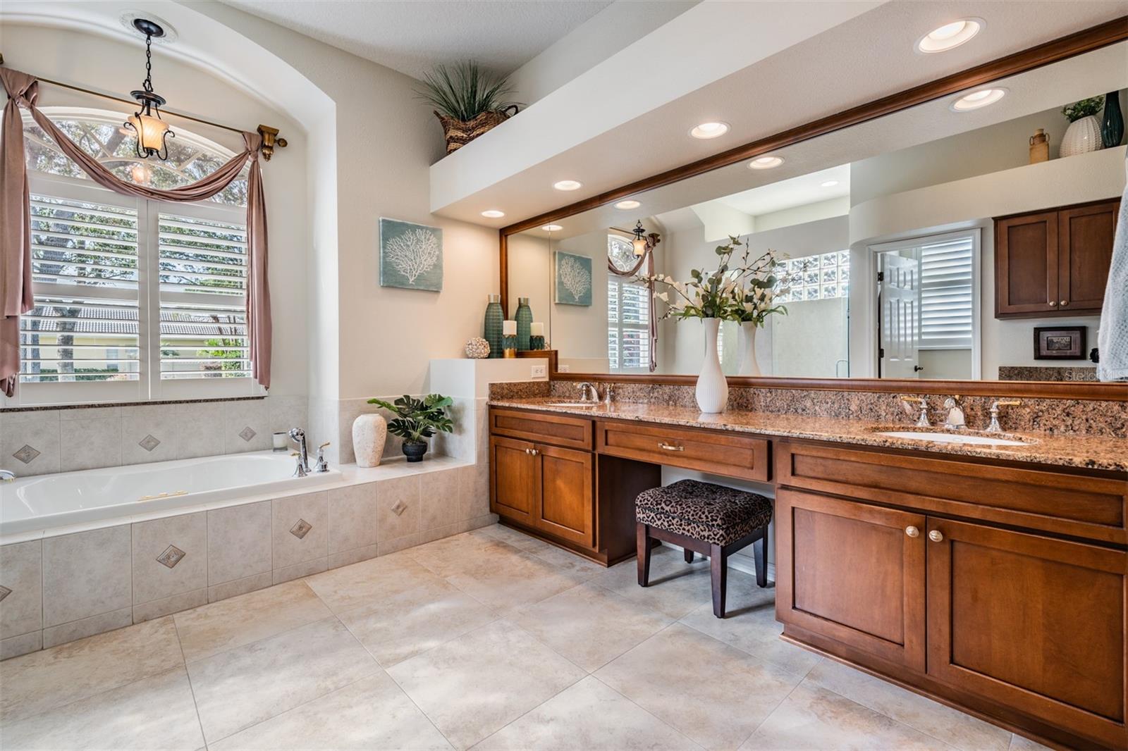 Updated Master Bathroom with Separate Walk In Shower and Tub, Double Vanities and Plantation Shutters.