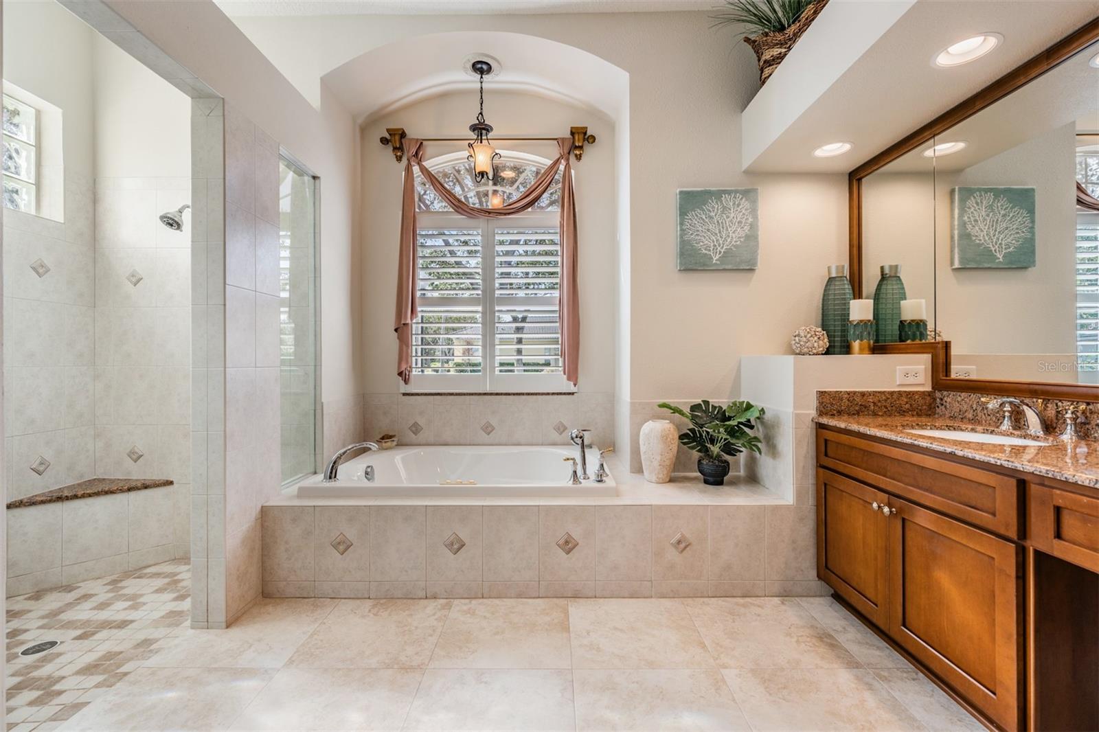 Updated Master Bathroom with Separate Walk In Shower and Tub, Double Vanities and Plantation Shutters.