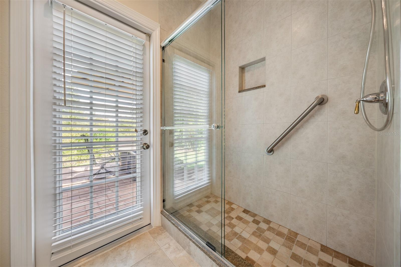 Pool Bath Shower with Seamless Glass and Handicap Rail.