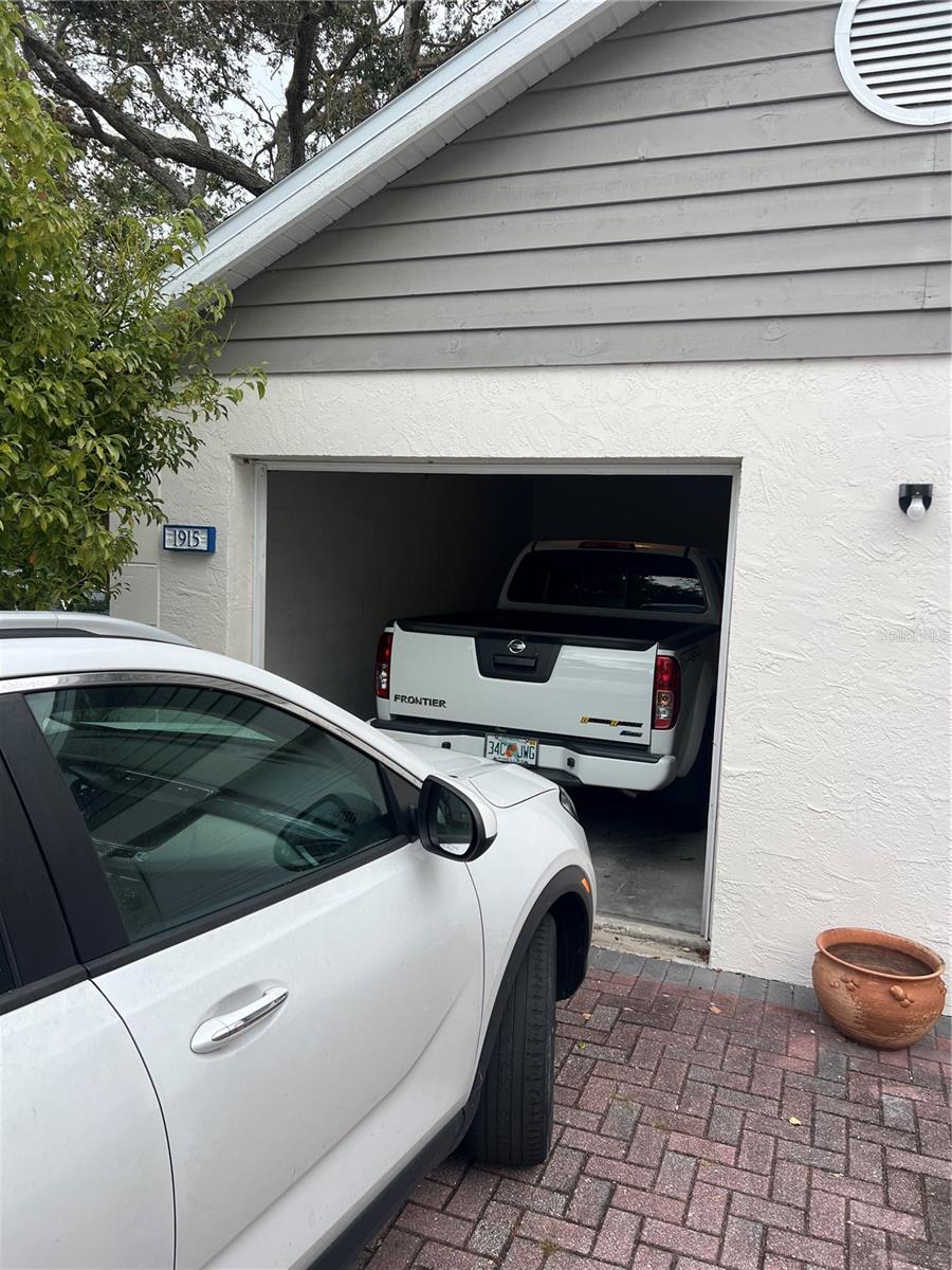 ..20 x 13 Garage size.. Garage does have working remote. There is a entry door on the backside of Garage. Owners can Park on Parking Pad Outside of Garage. There is also guest parking.