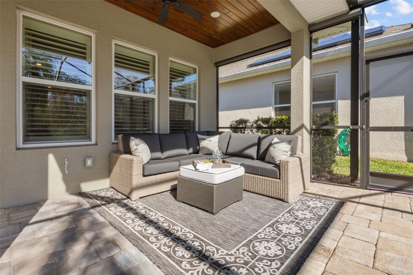 Back Patio with pavers, wood plank ceilings, full wall of sliders, fireplace