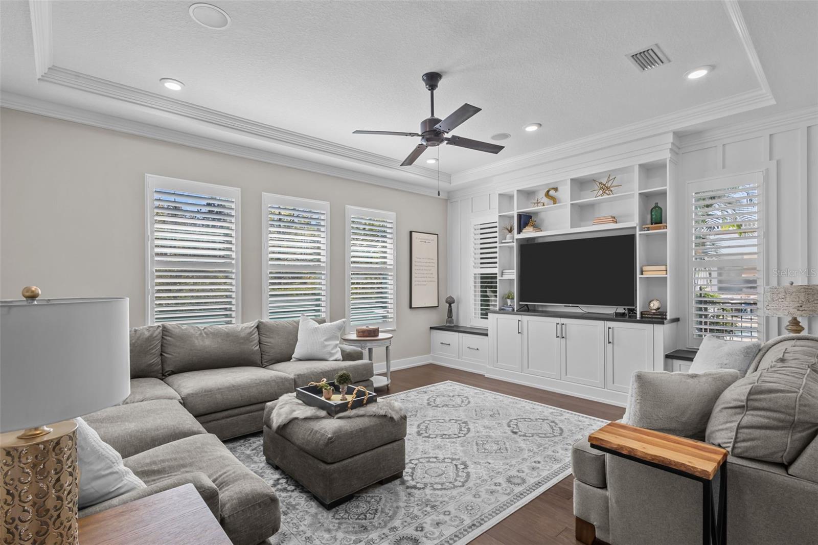 Bonus room in rear of home with trey ceilings and built in entertainment center