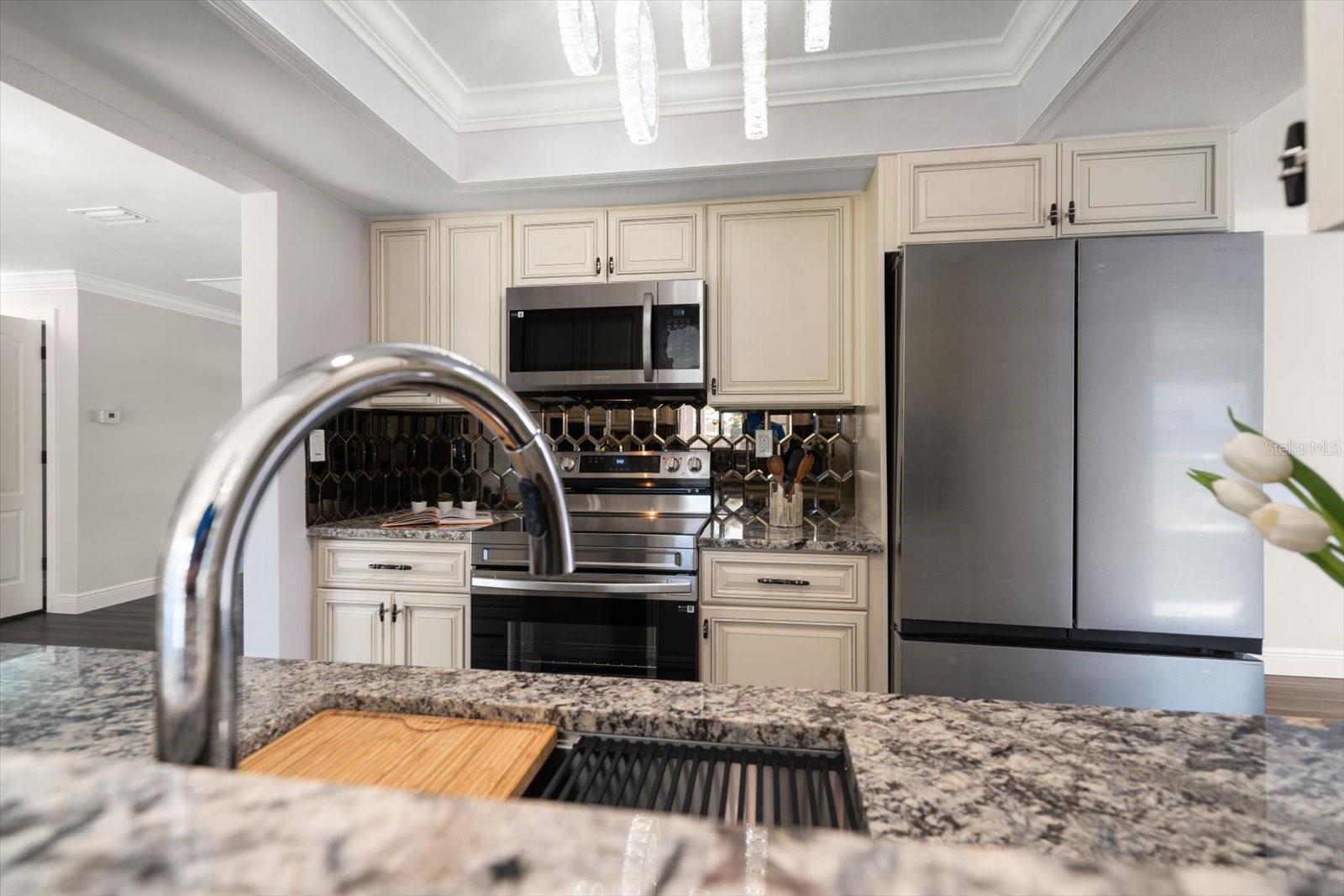 Modern, updated kitchen with peek a boo window to Florida room.