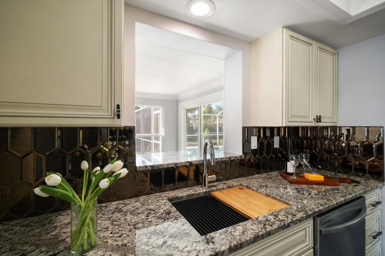 Large kitchen sink with peek a boo window to Florida Room