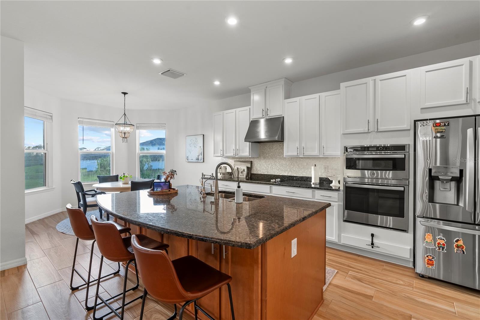 Kitchen with a vibrant breakfast bar and a charming dinette!