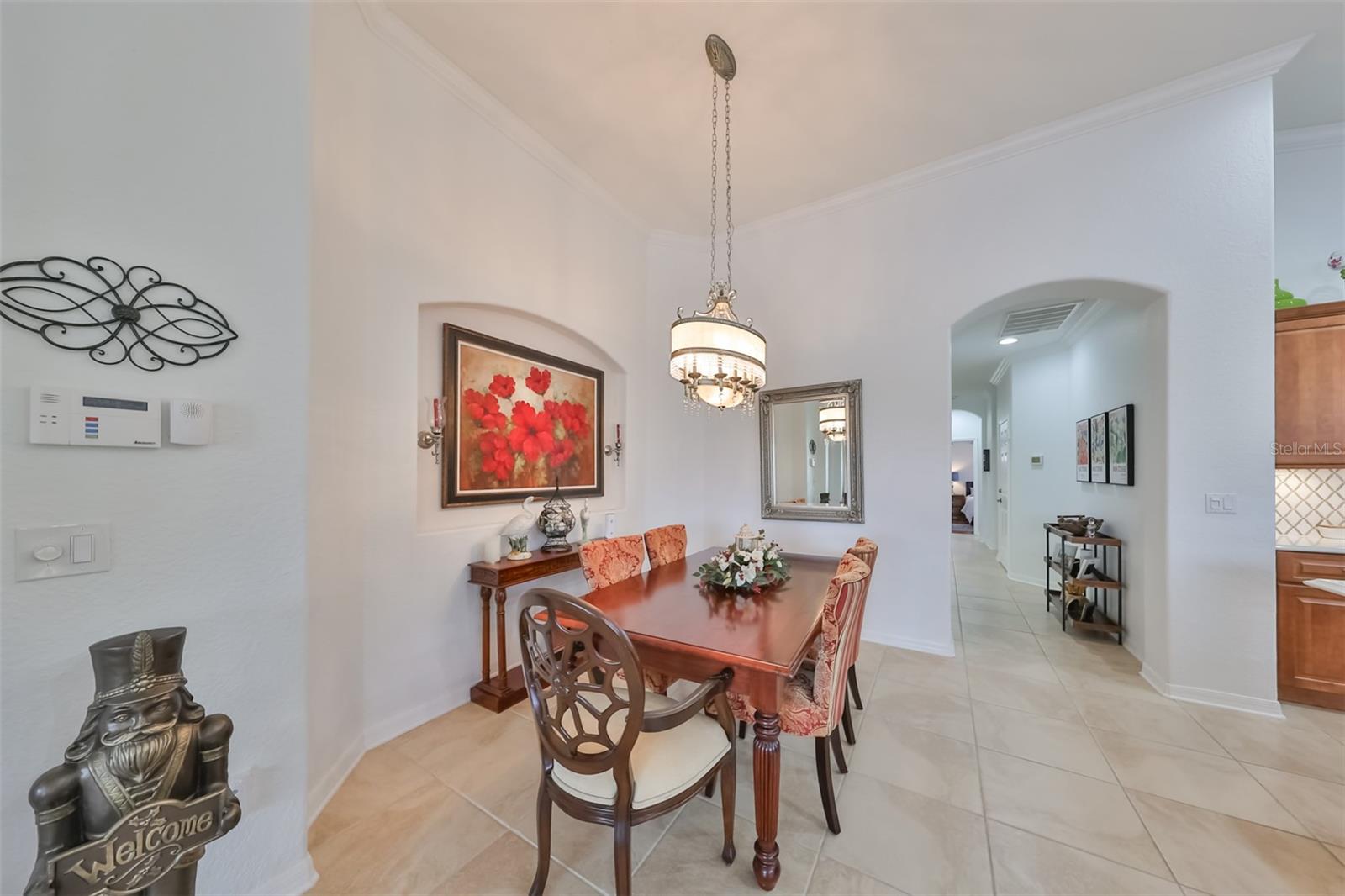 Dining room is open and inviting with water/golf course views. The unique lighting and art niche makes this space perfect for intimate dining or entertaining, with easy kitchen access.