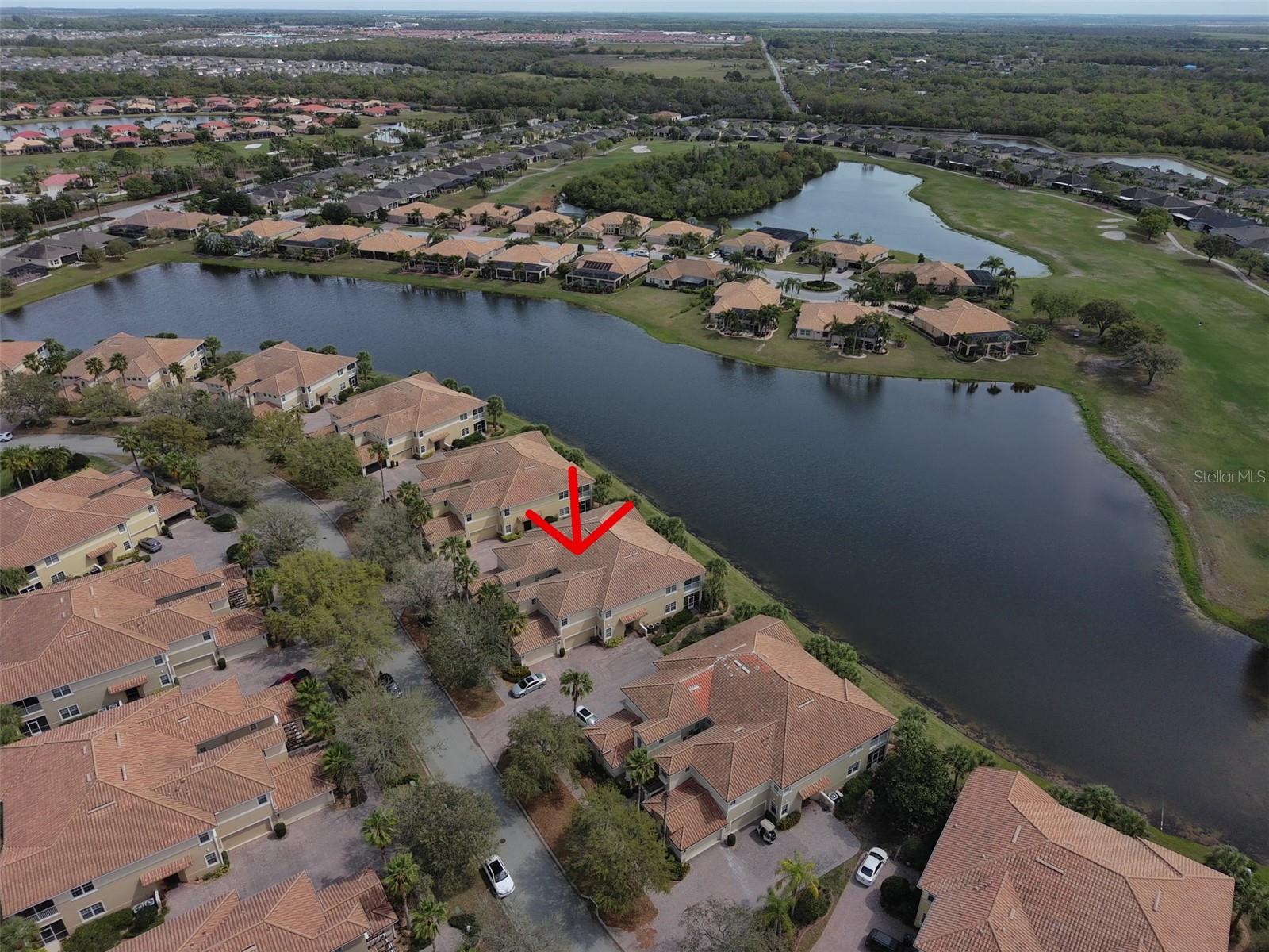 Ariel view of condo on the water with the golf course.