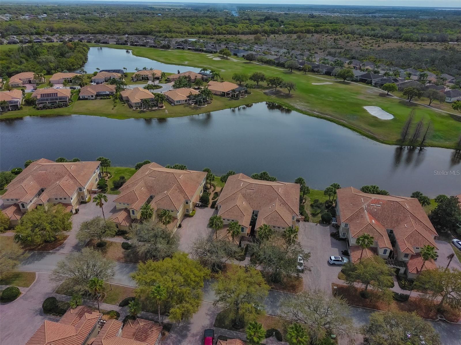 Ariel view of condo on the water with the golf course.