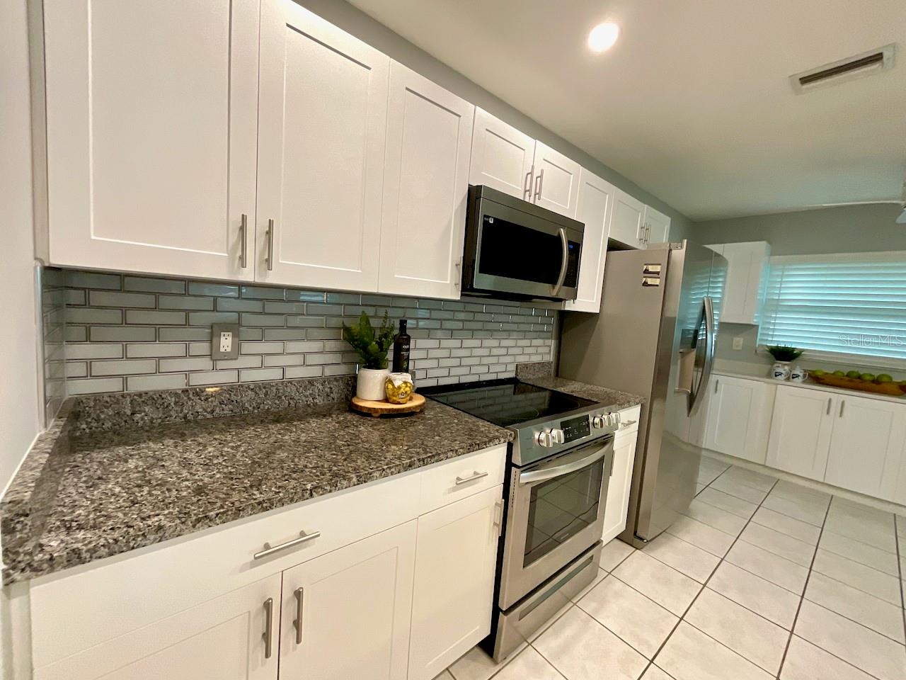 Kitchen range, microwave, and refrigerator area