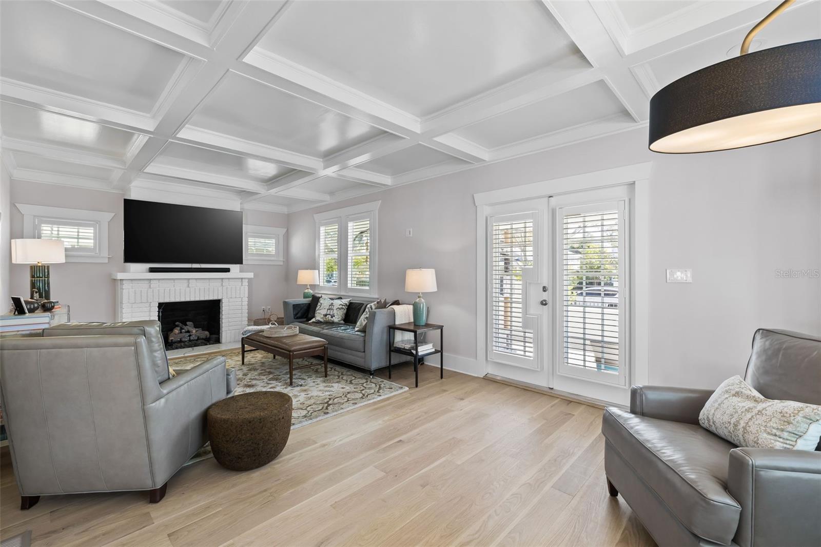 Step inside to the living with amazing light. Notice the intricate details of the ceiling and the original brick fireplace!