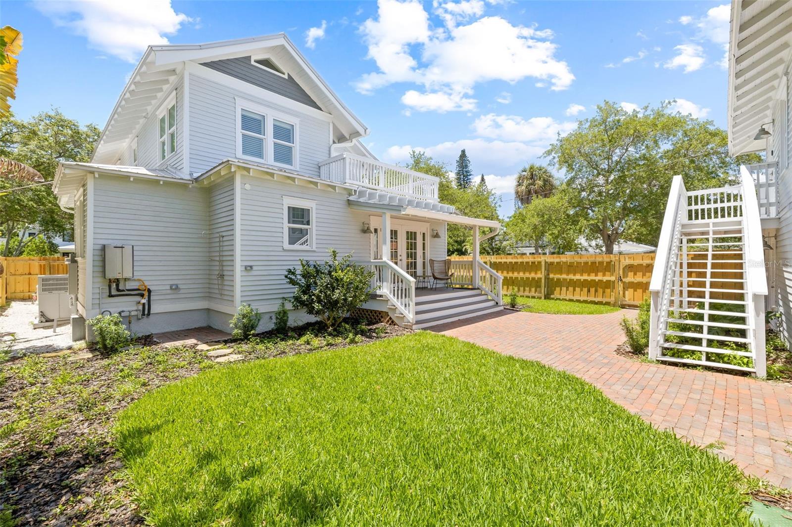 New privacy fence encloses backyard. Sit on the back porch in comfort while your kids or dogs play!!