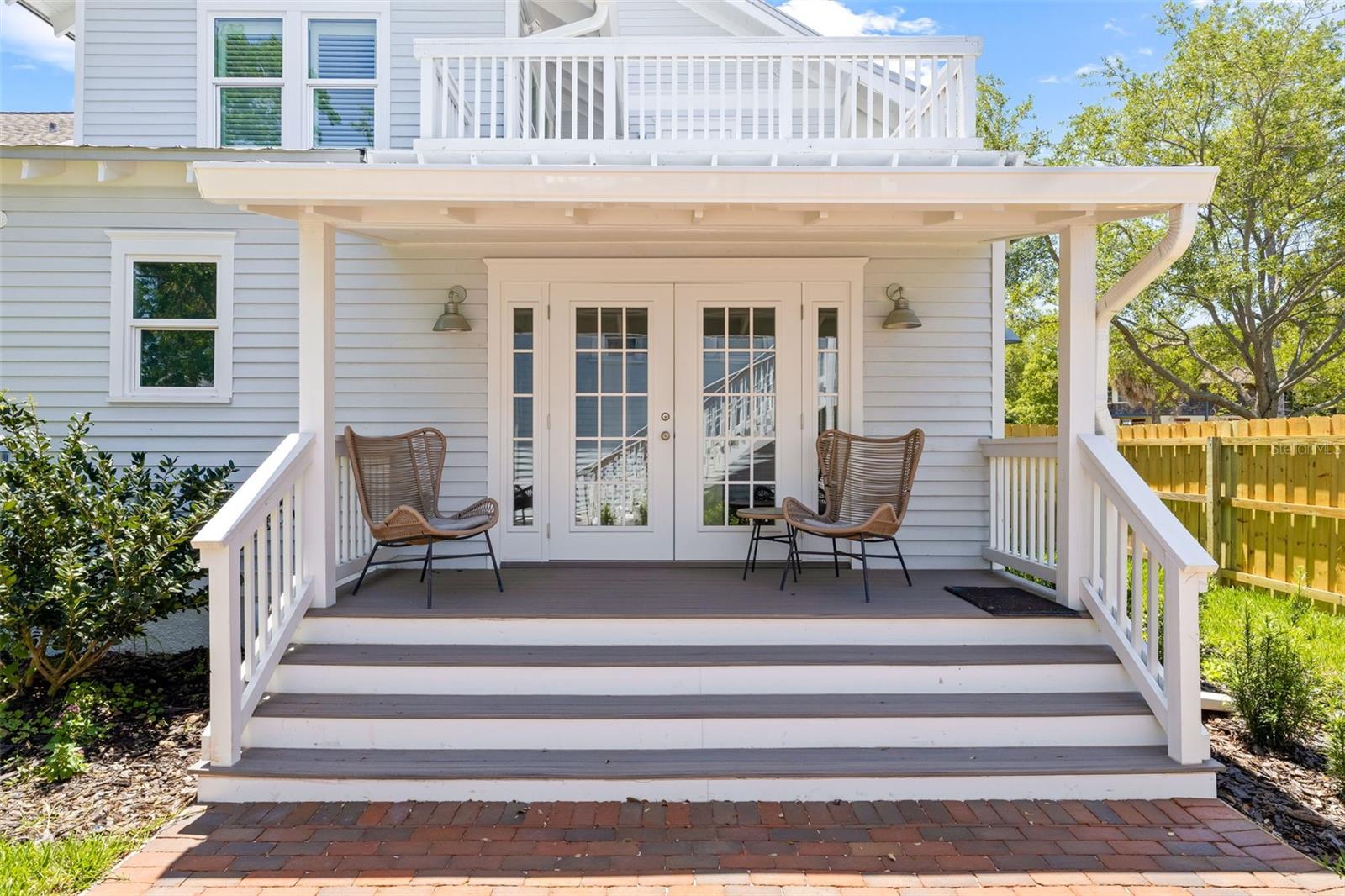 The covered back porch opens to kitchen through French Doors!