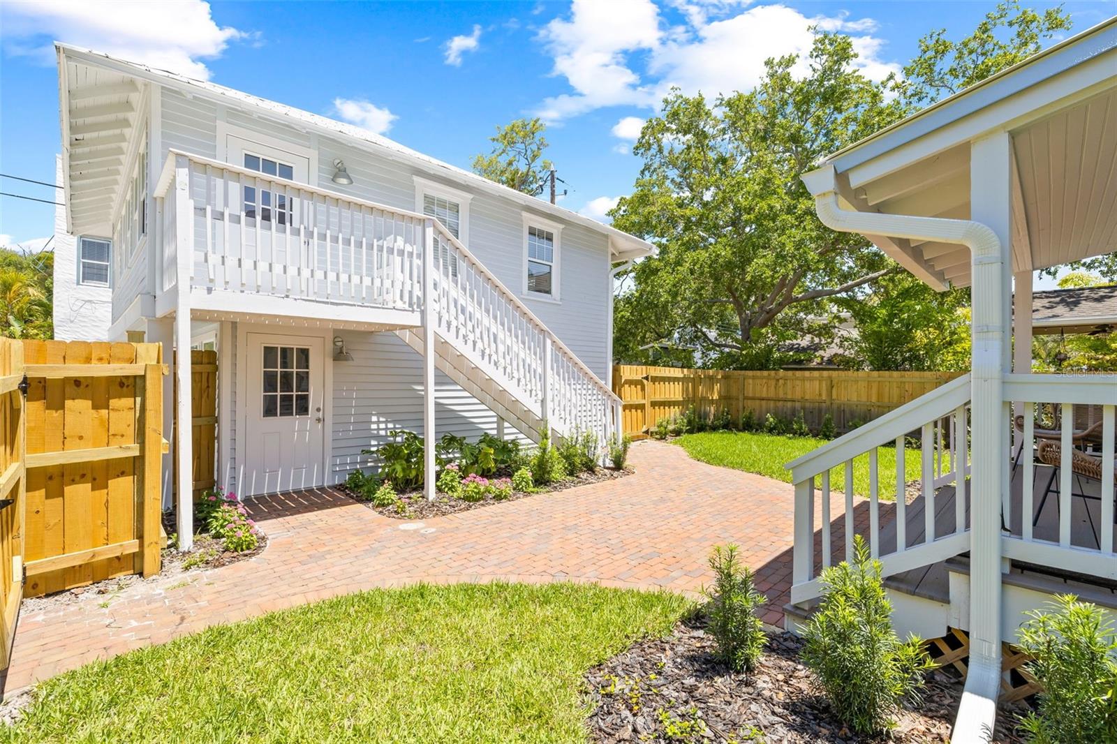 Large rear yard with new paver patio and Garage access