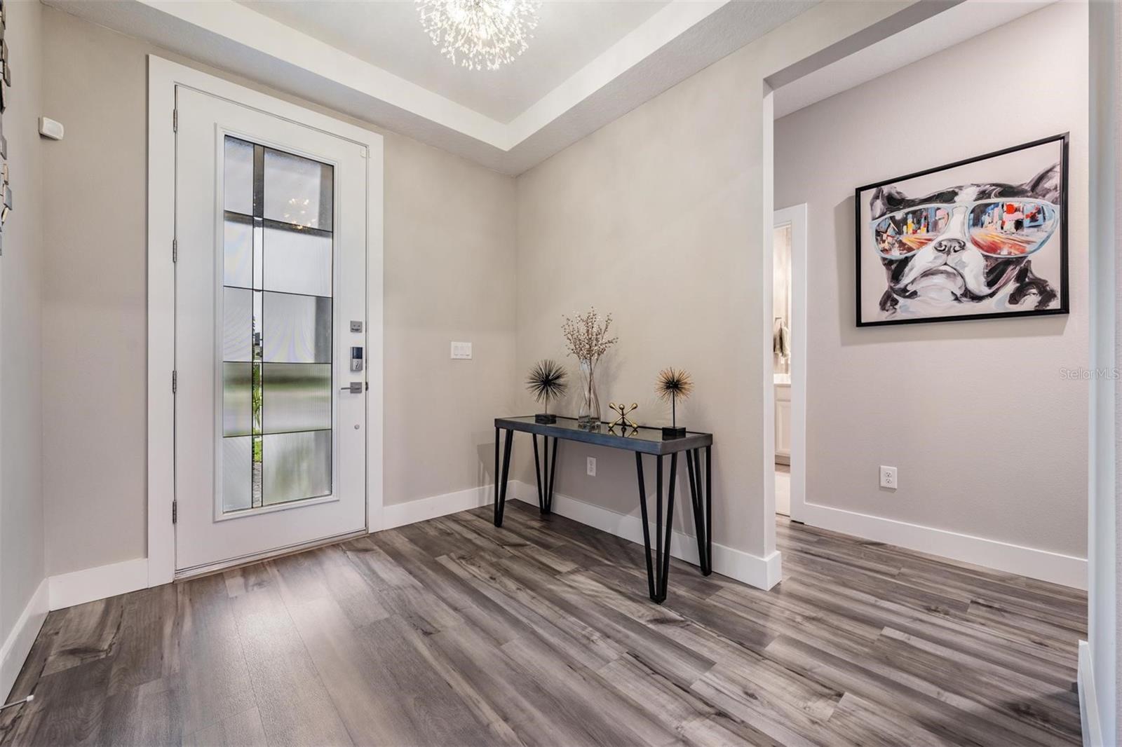 Entry with glass door that brightens the doorway