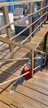 big rope railing in balcony and staircase to match this waterfront house too.