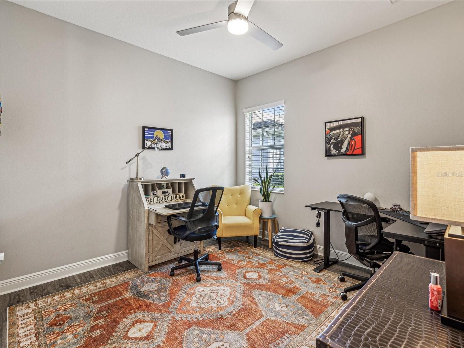 Bedroom 3 - This multi-use room can serve as a bedroom or office. The high ceilings with ceiling fan and north facing window make this cozy room feel larger.