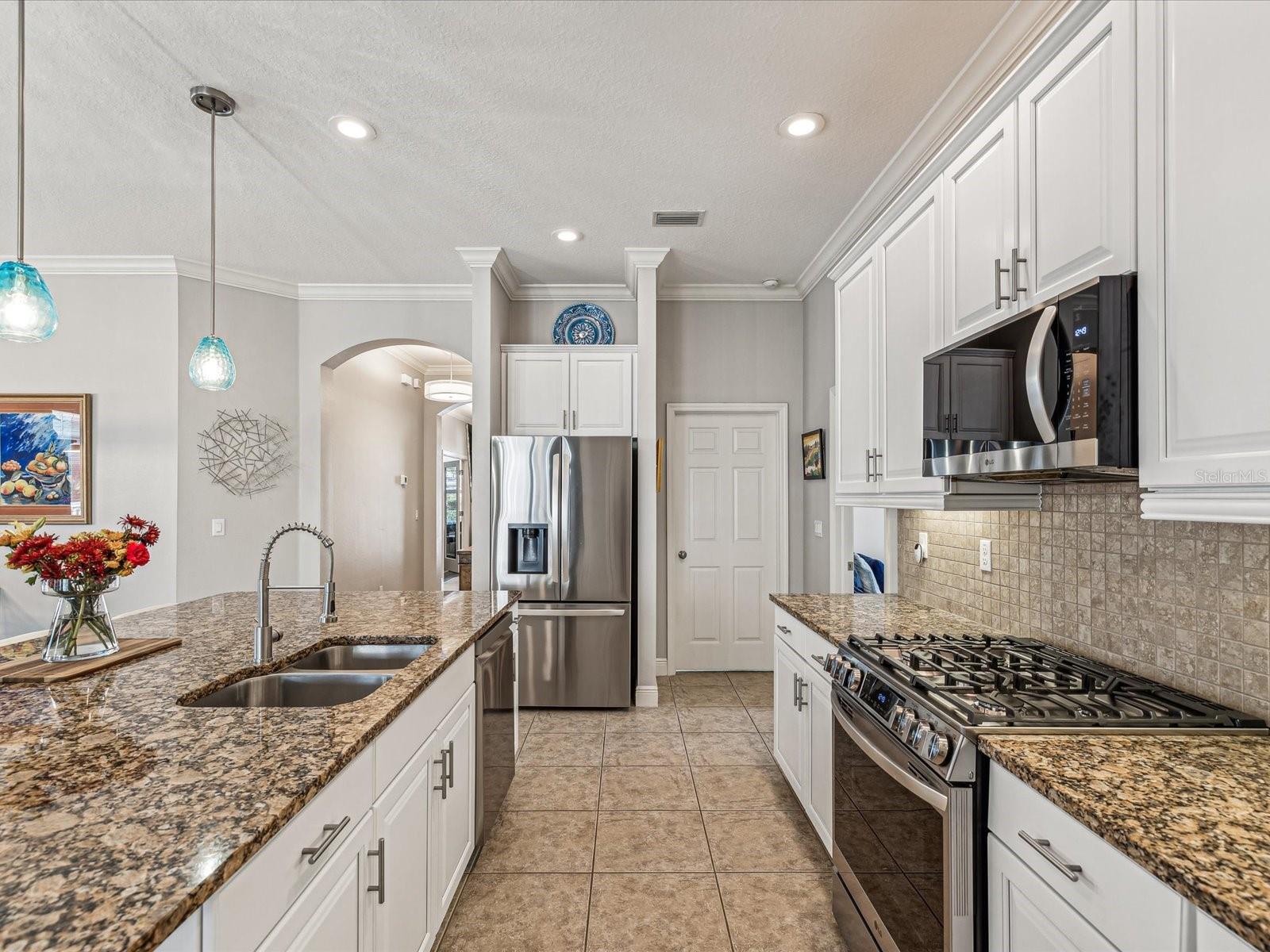 Stainless steel appliances that include a gas range, give this kitchen a modern flair while still incorporating traditional features.