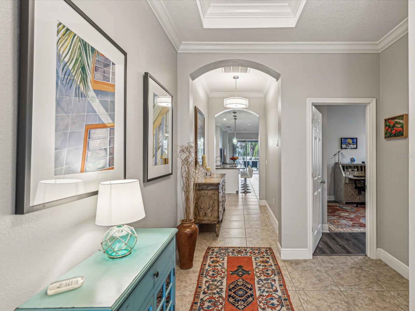 The view from the front door through the home also includes two bedrooms in the front of the home and a bathroom immediately to the right of the entrance.