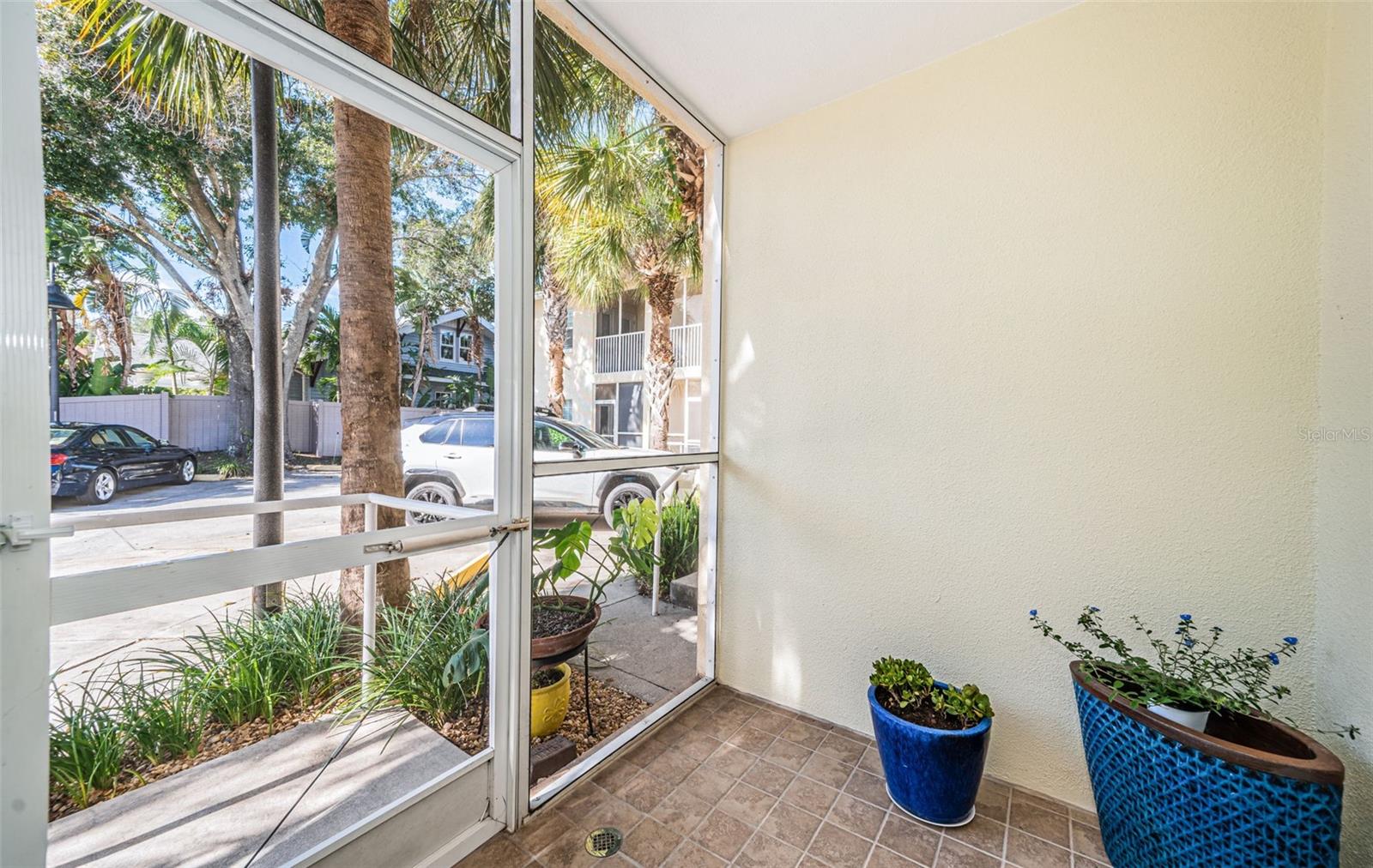 Step out back to one of two screened porches with your reserved parking spot beyond.