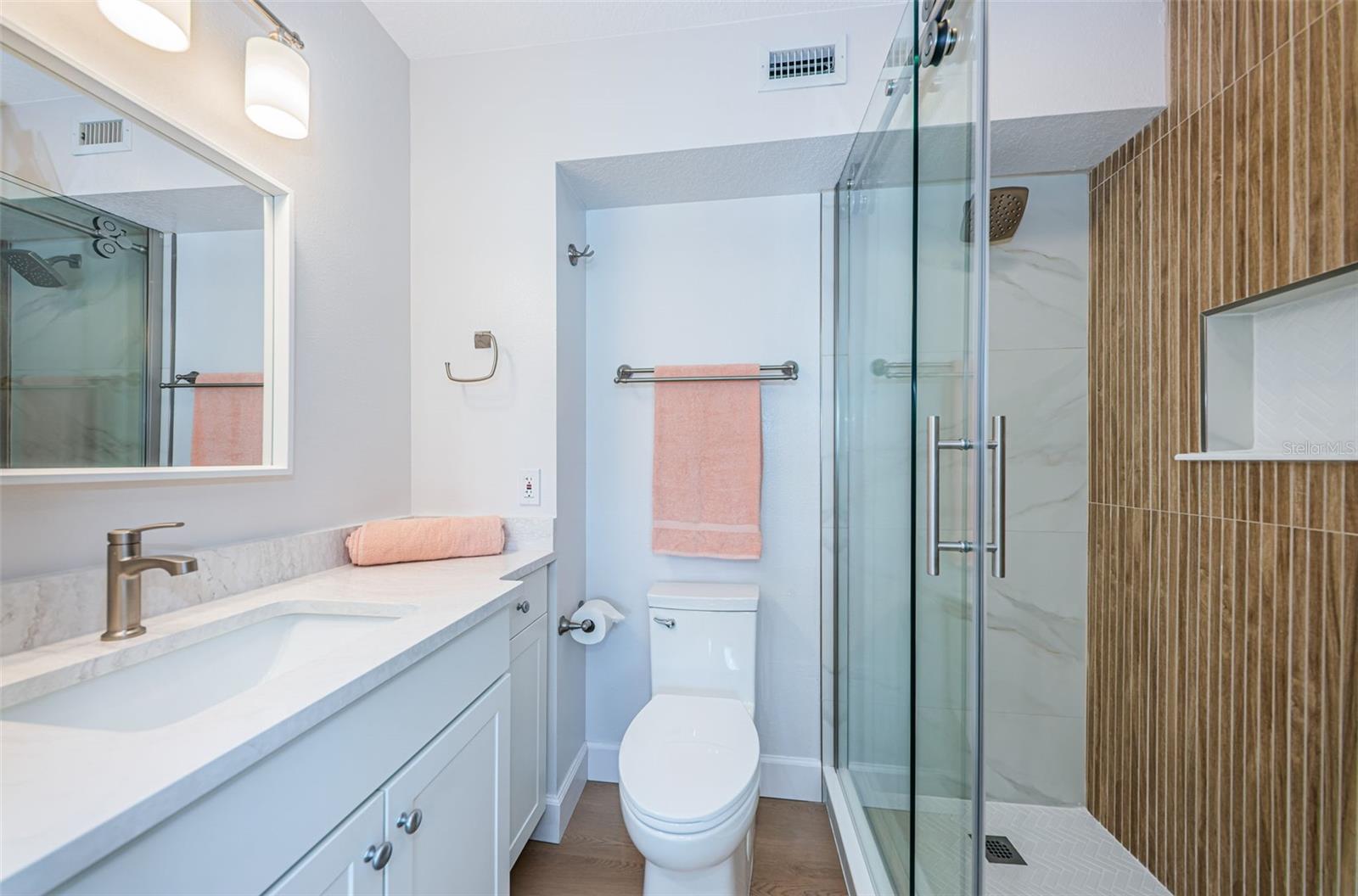 En-suite bathroom of bedroom 1 with a new step in shower.