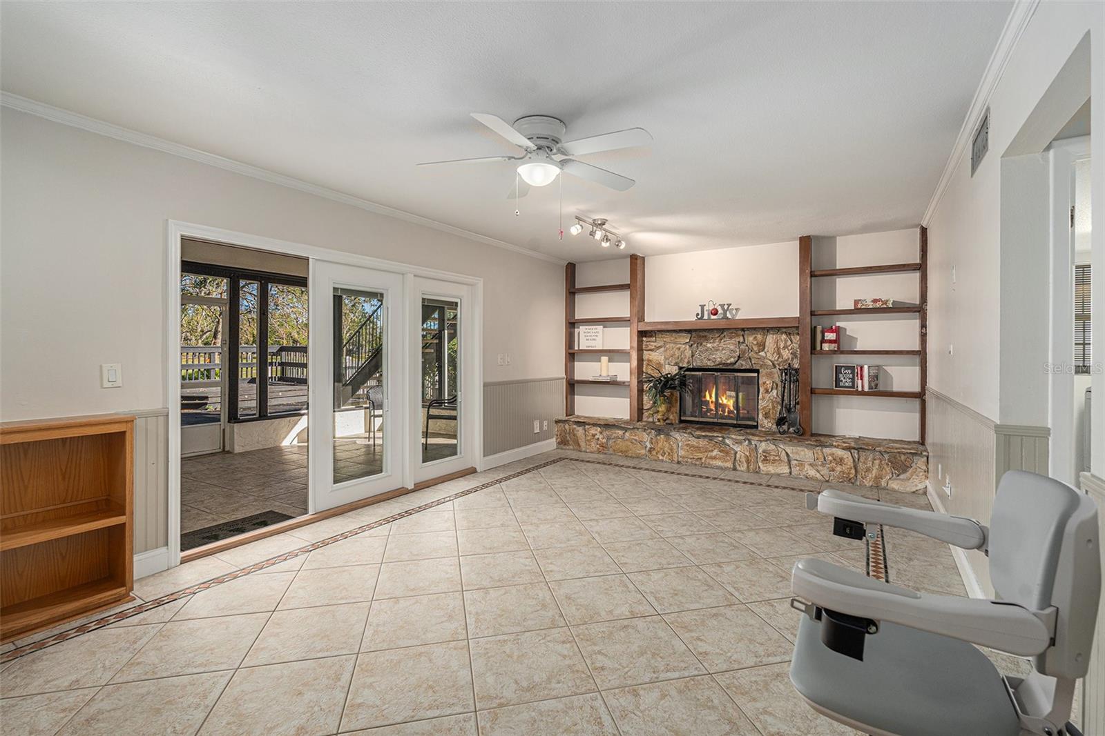 Family room with large doors leading out to screened lanai and pool area.