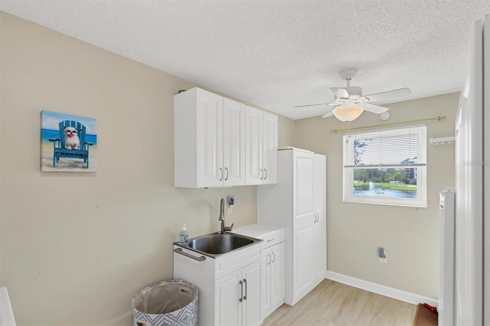 Laundry room storage area and utility sink. Comes with a water view!