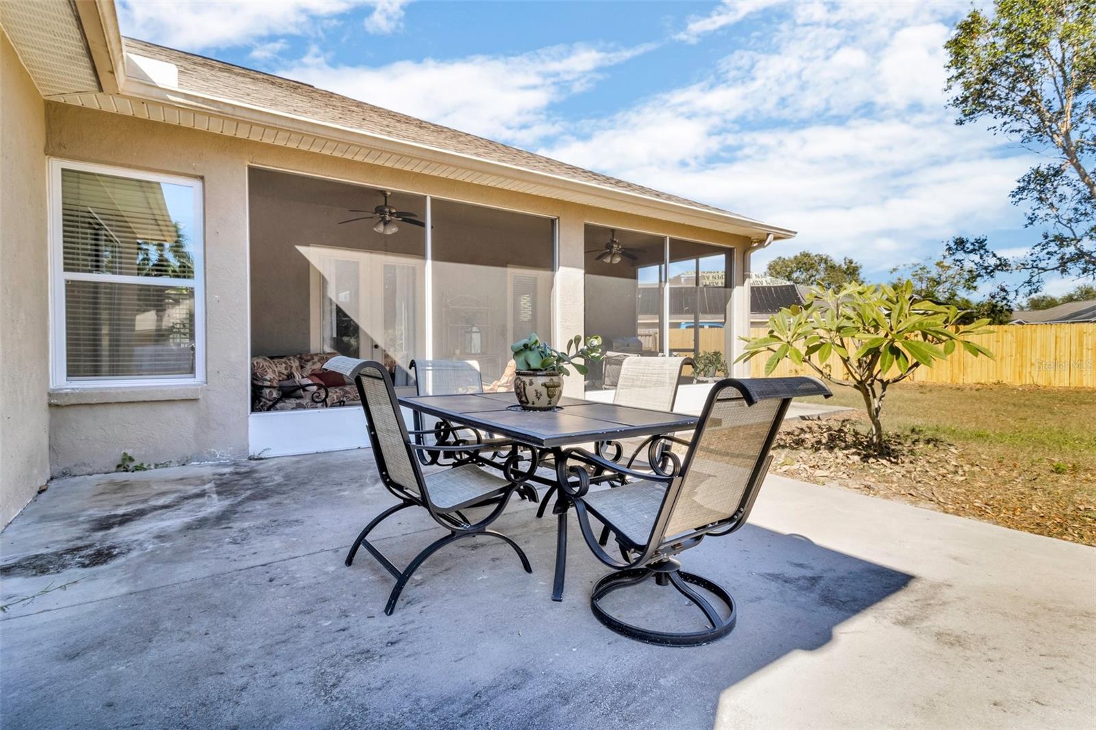 Extended cement pad wraps around back of home