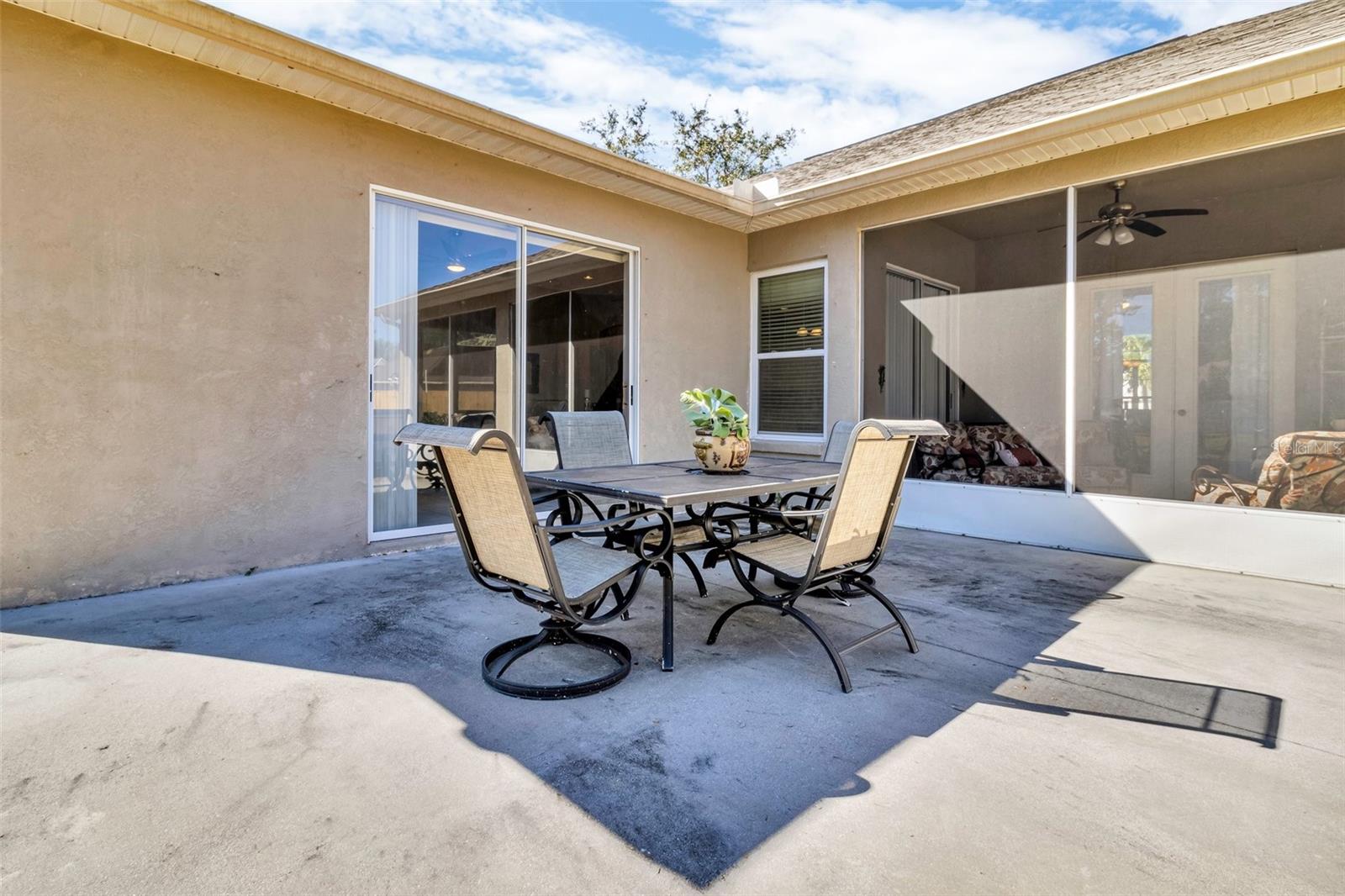 Extended cement pad wraps around back of home