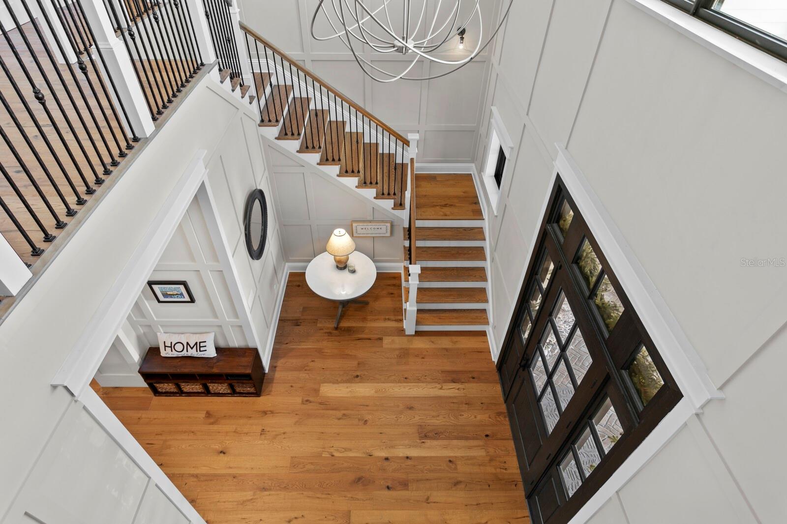 Two story open foyer with European oak stairs