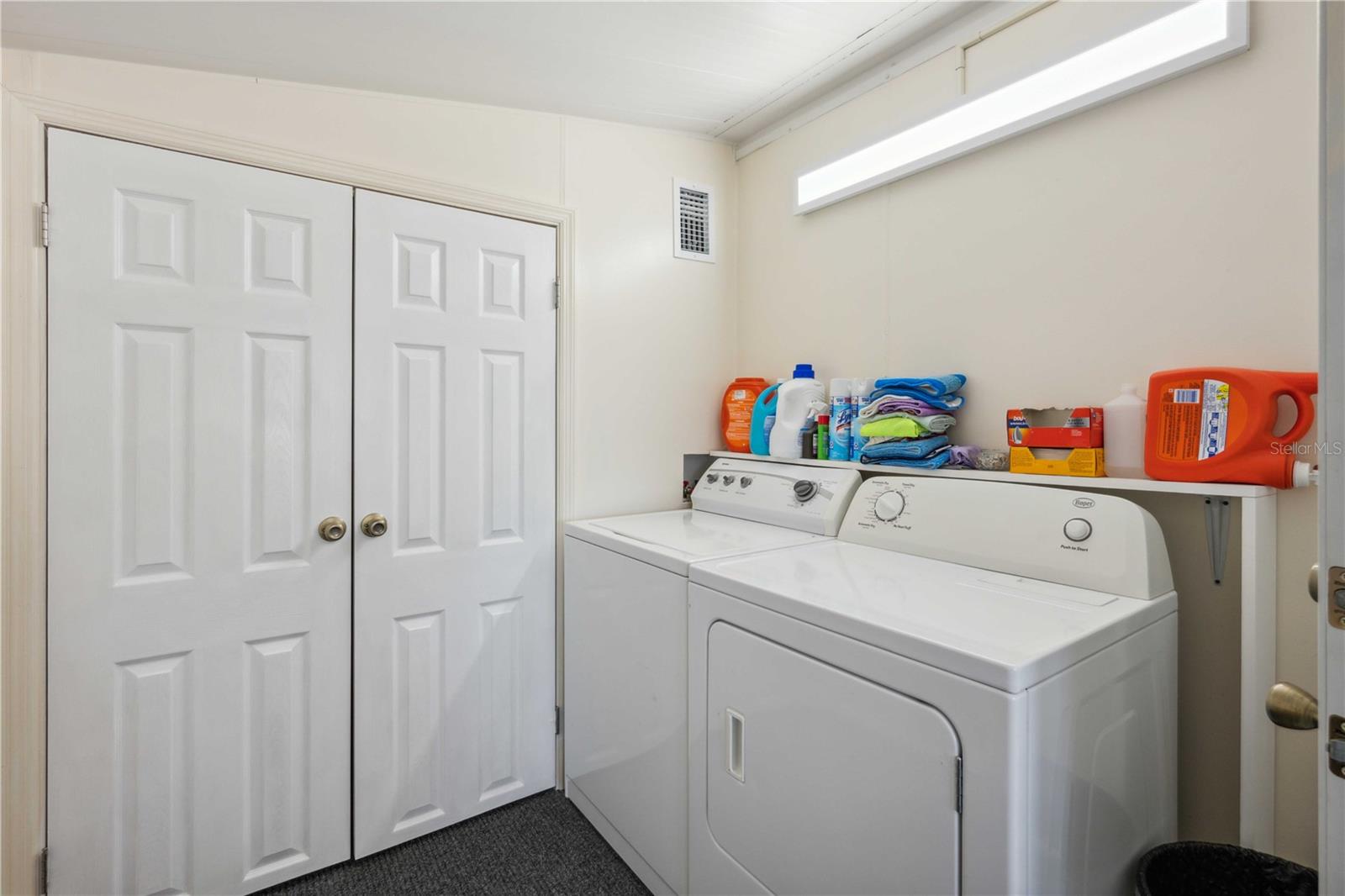 Inside laundry area with extra storage.