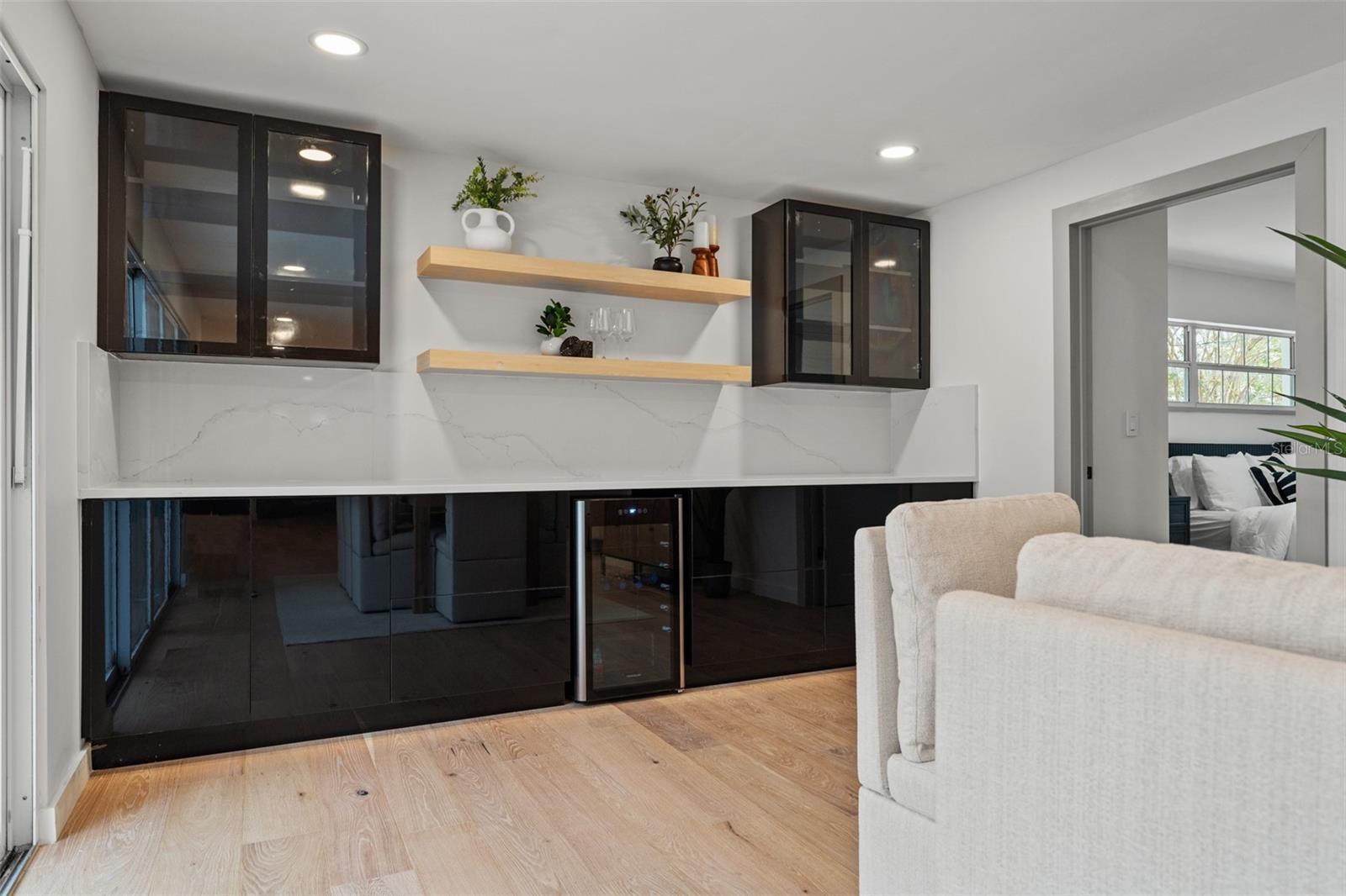 Dry bar with wine cooler and floating shelves