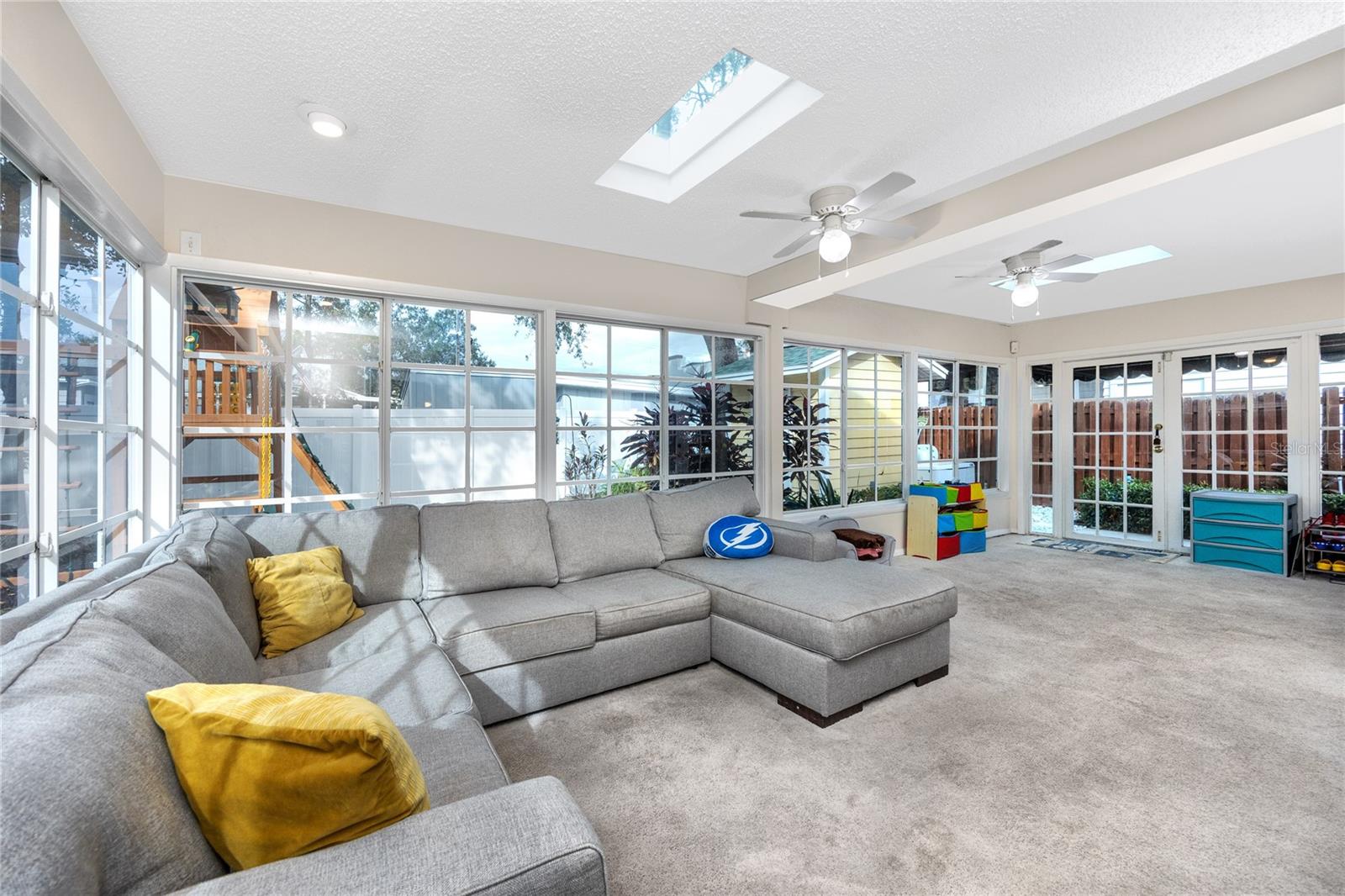 Large Florida room with tinted windows and sunlights allow for tons of natural light.