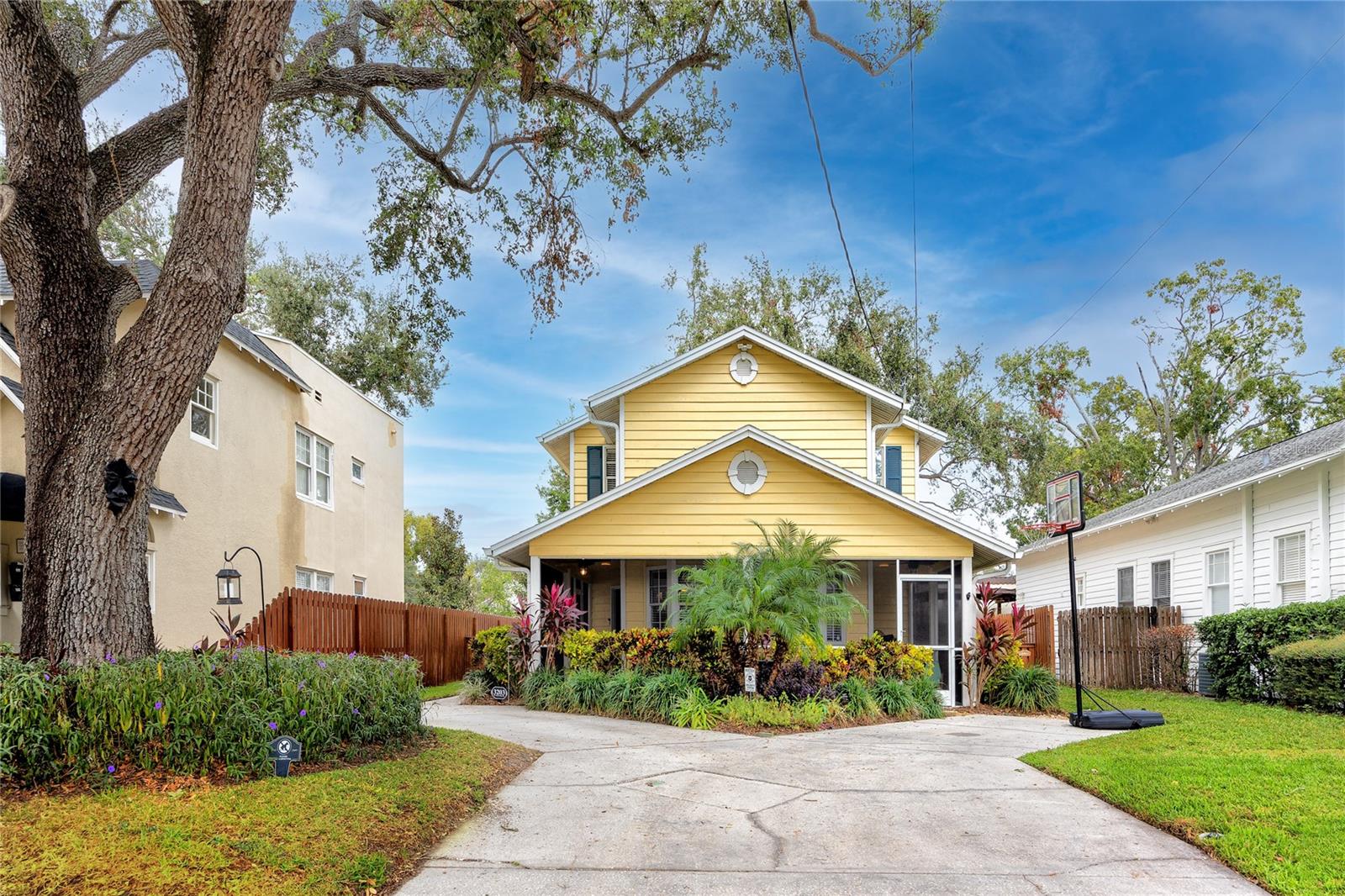 Set back from the street with mature landscaping and parking for multiple cars.