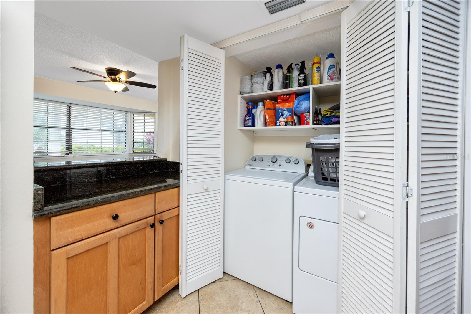 Laundry closet in the kitchen fits full sized washer & dryer.